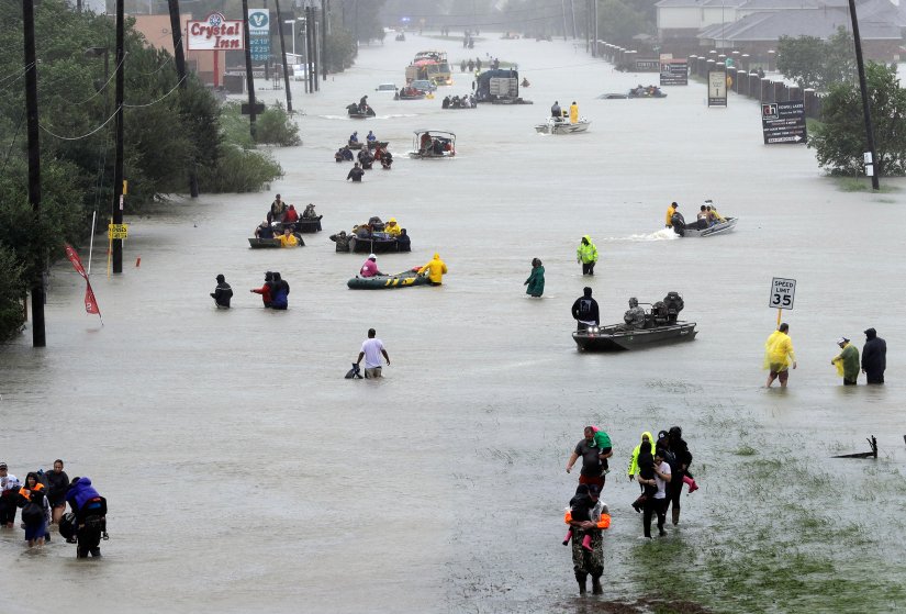 Rescue boats fill a flooded street at flood victims are evacuated as floodwaters from Tropical Storm Harvey rise Monday, Aug. 28, 2017, in Houston. (AP Photo/David J. Phillip)