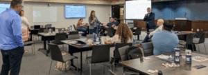 UT San Antonio faculty and staff participating in a professional development event held in a large conference room